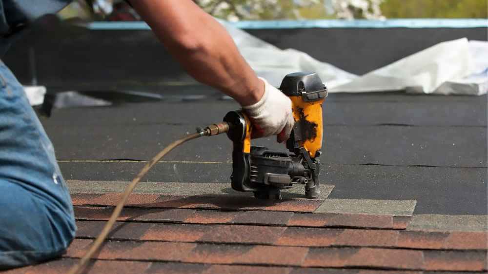 Contractor performing roof repair on a residential home